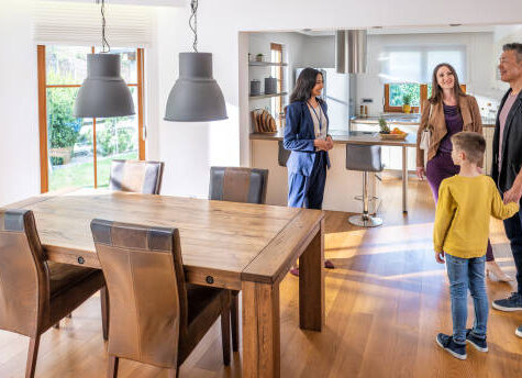 Female real estate agent showing modern apartment to family with child
