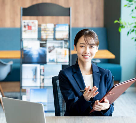 A female consultant working at the reception desk A female consultant working at the reception desk